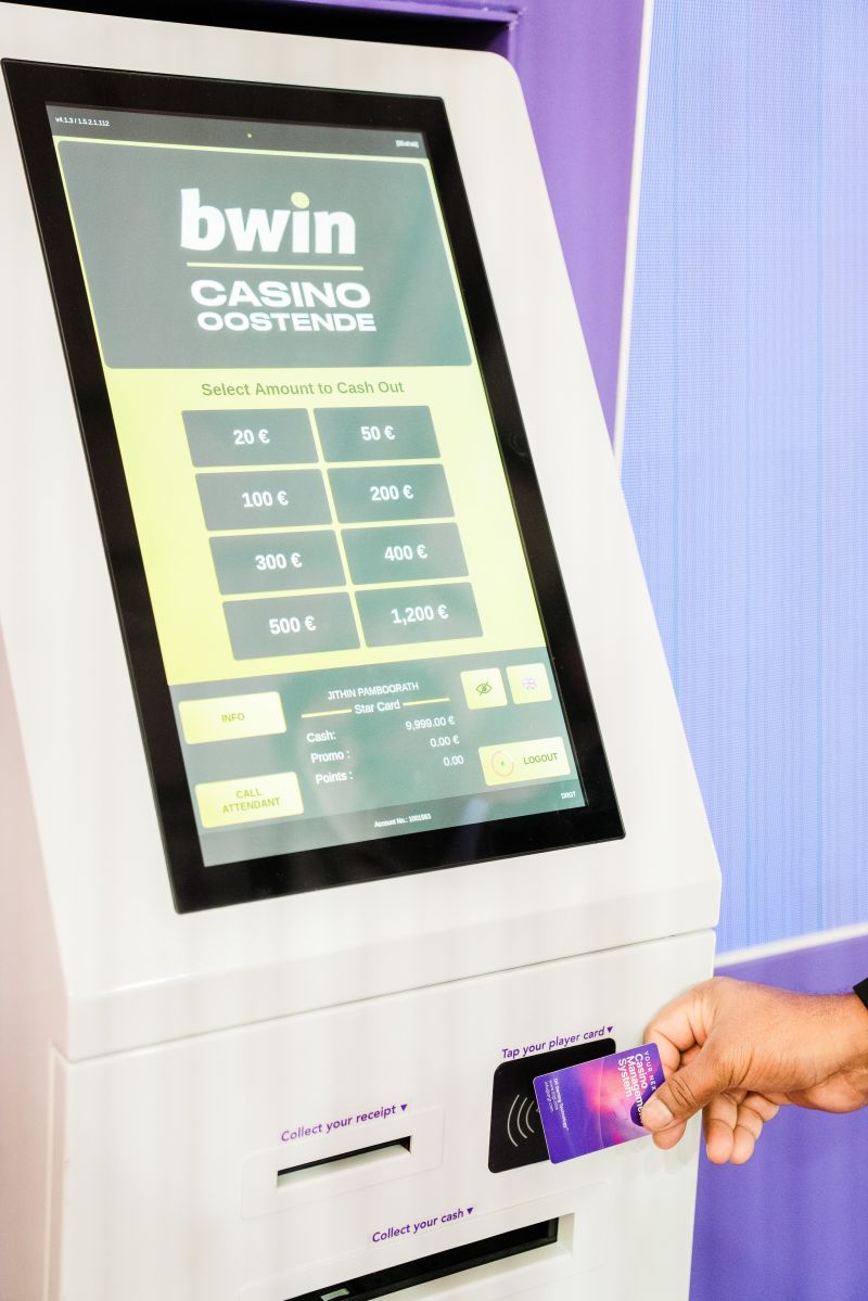 Kiosco drCARM mostrando la pantalla de retiro de efectivo con la marca bwin Casino Oostende y un jugador acercando su tarjeta